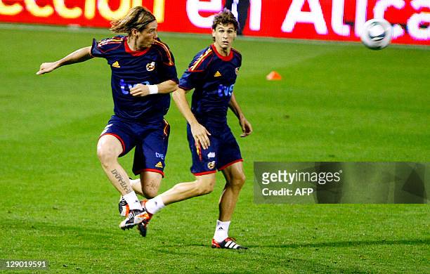 Spain's forward Fernando Torres and Spain's forward Fernando Llorente vie for the ball during a training session in Alicante on October 10 on the eve...