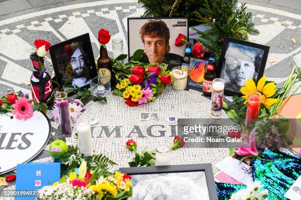 Flowers and candles are left on the "Imagine" memorial in honor of John Lennon on the 40th anniversary of his death at Strawberry Fields in Central...