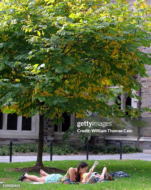 Claudia Kelley , of San Francisco, California and Cameron Langford of Davidson, North Carolina lay on the grass and read in a courtyard at Princeton...