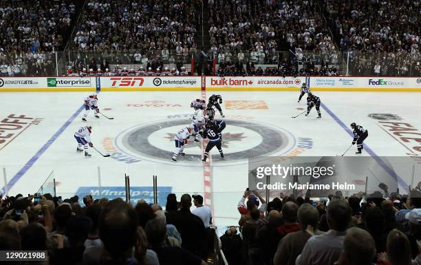 Play begins after the first faceoff in a game between the Winnipeg Jets and the Montreal Canadiens in NHL action at the MTS Centre on October 9, 2011...