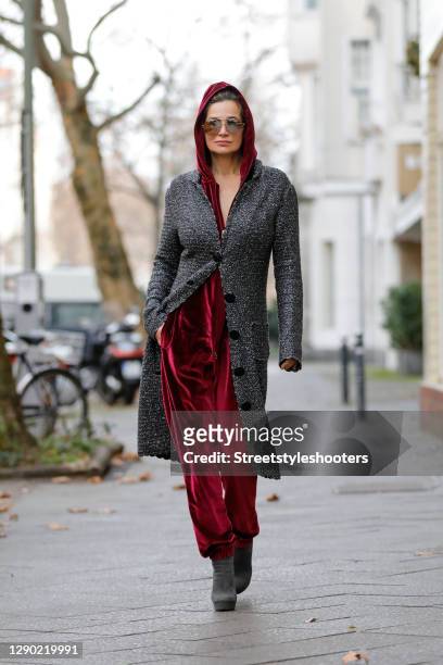 German actress Alexandra Kamp wearing a wine red colored velvet jumpsuit by onepiece, dark grey ankle boots with glitter heels by Miu Miu, sunglasses...