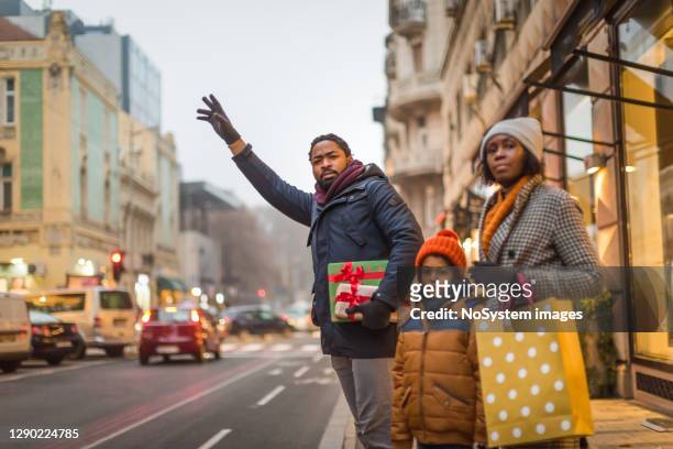 waiting for taxi after christmas shopping - christmas decorations in store stock pictures, royalty-free photos & images