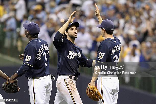 Yuniesky Betancourt, Ryan Braun and Craig Counsell of the Milwaukee Brewers celebrate after they won 9-6 against the St. Louis Cardinals during Game...