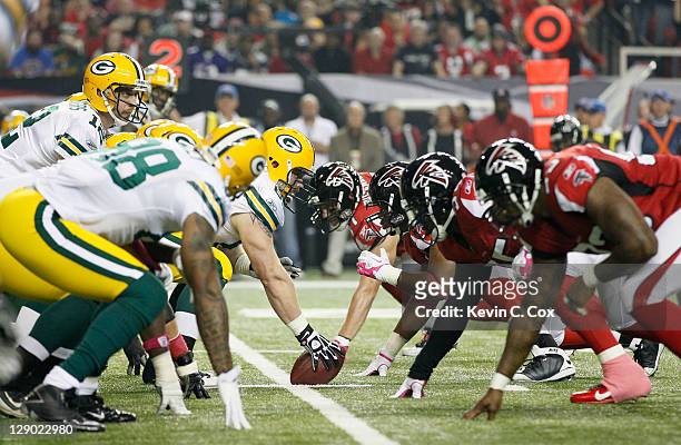 The Green Bay Packers line up with the Atlanta Falcons on the line of scrimmage at Georgia Dome on October 9, 2011 in Atlanta, Georgia.
