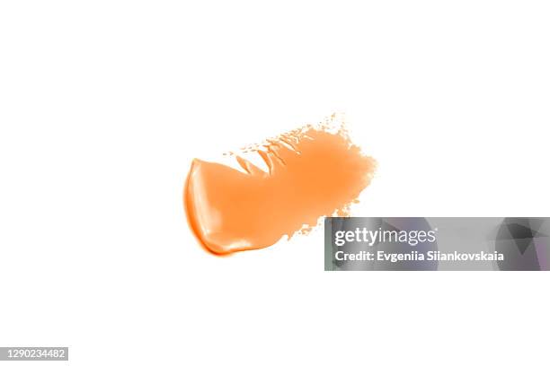 orange smear of creamy eye shadow isolated on white. - orange creme stock pictures, royalty-free photos & images