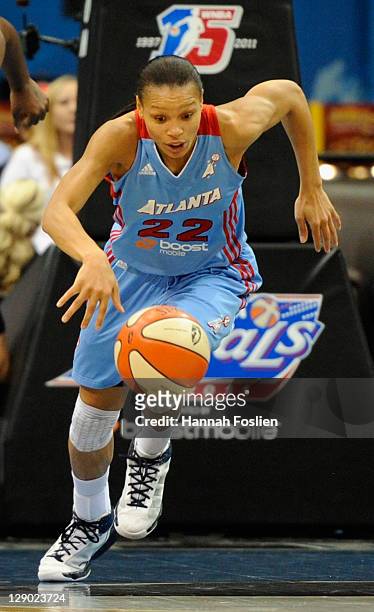 Armintie Price of the Atlanta Dream dribbles the ball against the Minnesota Lynx in Game One of the 2011 WNBA Finals on October 2, 2011 at Target...