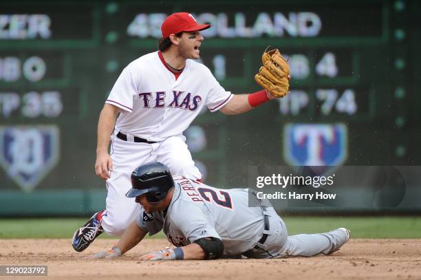 Ian Kinsler of the Texas Rangers reacts as Jhonny Peralta of the Detroit Tigers slides in safe at second base on a double in the third inning of Game...