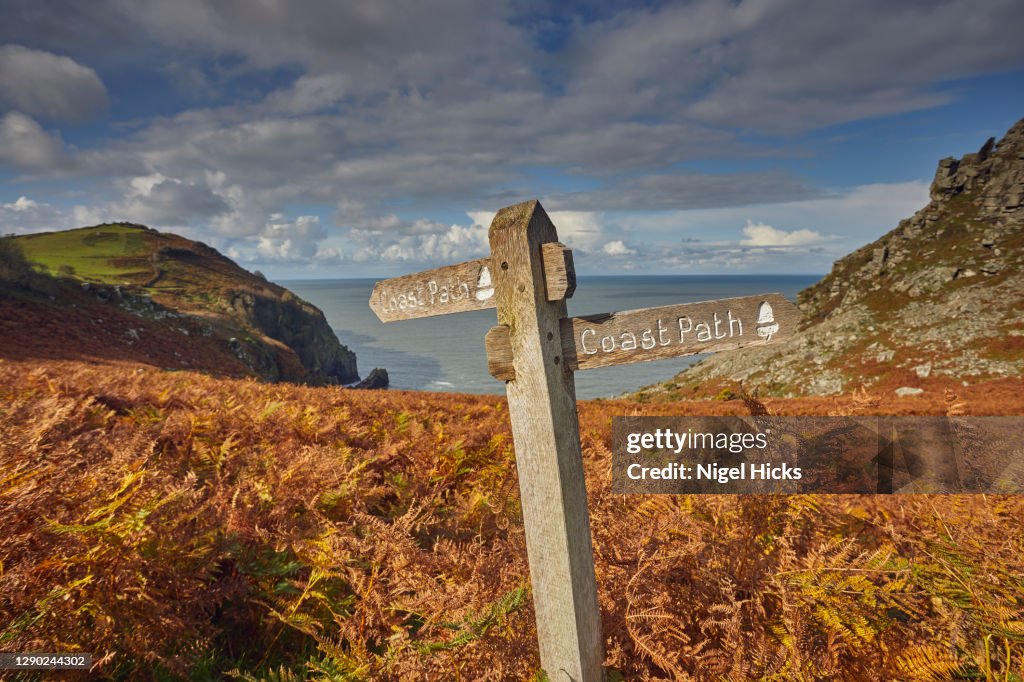 A coast path sign, on the Southwest Coast Path, seen at the Valley of Rocks, near Lynton, in Exmoor National Park, Devon, Great Britain.