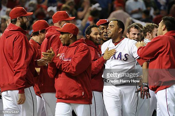 The Texas Rangers celebrate at home plate after a walk off grand slam home run from Nelson Cruz in the bottom of the 11th inning to win Game Two of...