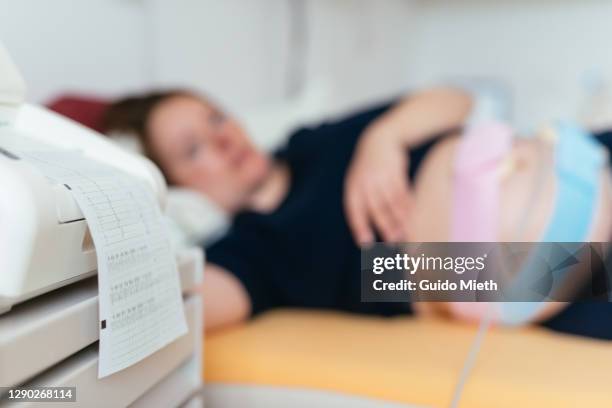 doctor doing ctg trace on a pregnant women in hospital. - foetus stock pictures, royalty-free photos & images