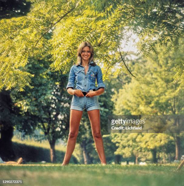 British-Australian singer and actress, Olivia Newton-John, in a denim shirt and matching hot pants, circa 1974. The portrait is part of the shoot for...