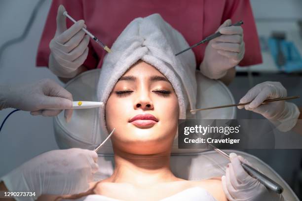 woman having facial injections  and medical equipment of skin care. - tratamento a laser imagens e fotografias de stock