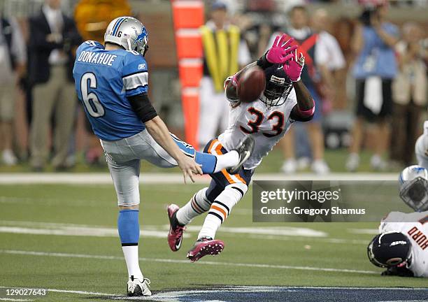 Charles Tillman of the Chicago Bears tries to block a fourth quarter punt off the foot of Ryan Donahue of the Detroit Lions at Ford Field on October...