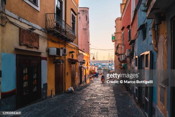 alley to the harbor, procida island, italy - naples italy stock pictures, royalty-free photos & images