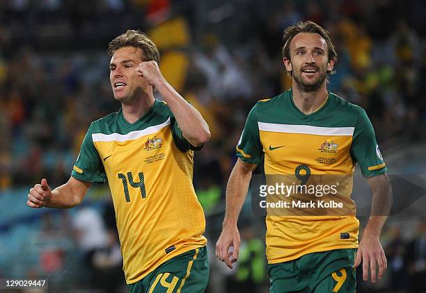 Brett Holman of the Socceroos celebrates after scoring a goal during the FIFA World Cup Asian Qualifier match between the Australian Socceroos and...