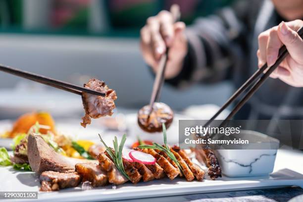 close-up of roasted beef rib on plate - rib food stock pictures, royalty-free photos & images