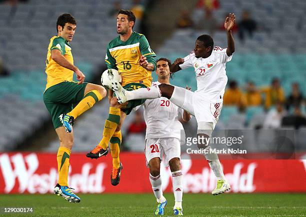 Rhys Williams and Carl Valeri of Australia and Amad Ali Sulaiman Al Honsi and Mohammed Hamed Al Makhaini of Oman contest possession during the FIFA...