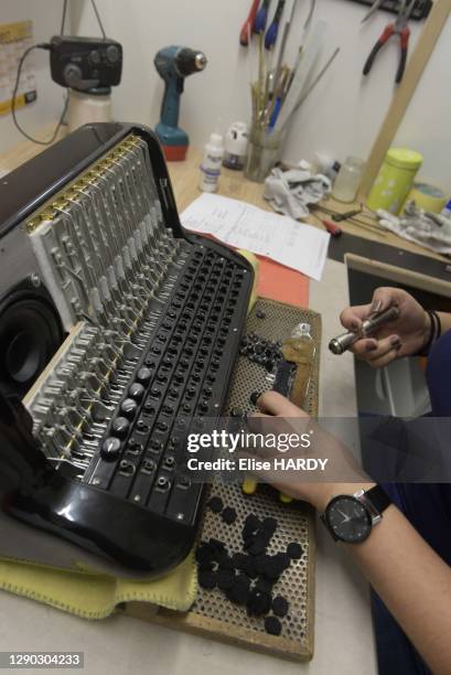 Fixation des feutres et des boutons accordéons à la manufacture des accordéons Cavagnolo à Béligneux dans l'Ain en France, le 26 septembre 2017.