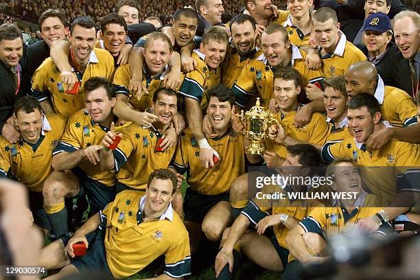 Australian players pose with the Webb Ellis Cup after the 1999 Rugby World Cup final match France vs Australia at the Millennium Stadium in Cardiff...