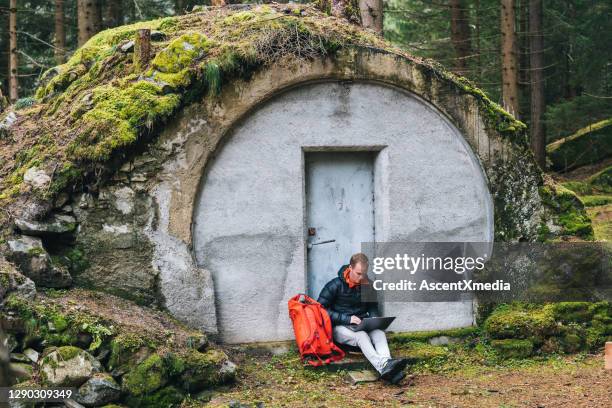 young man works remotely in lush forest in the morning - house remote location stock pictures, royalty-free photos & images