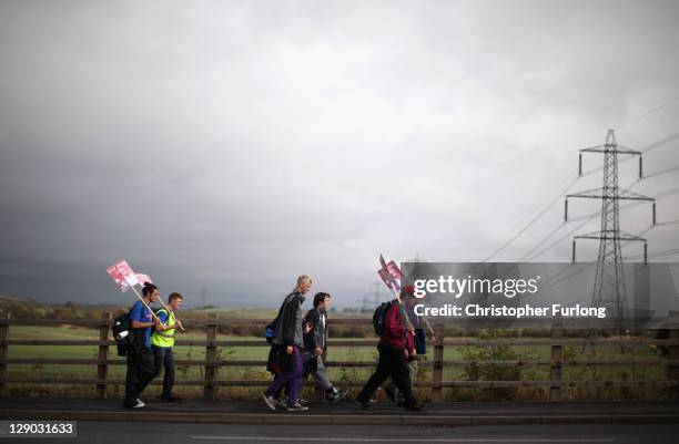 Marchers make their way through the South Yorkshire village of Royston as they re-enact the Jarrow Crusade for employment on October 11, 2011 in...