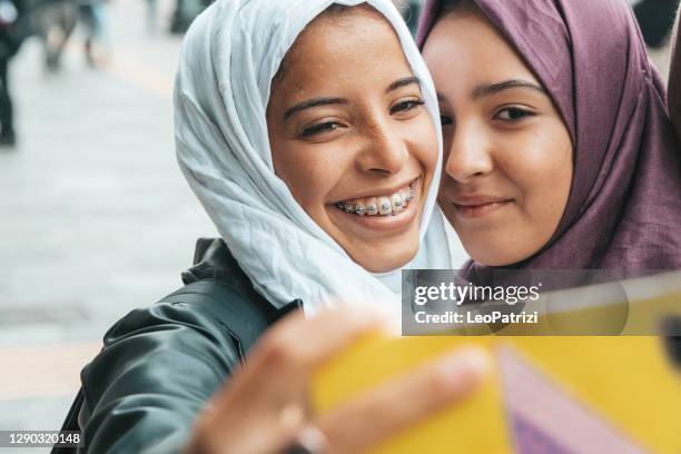 two happy friends smiling to camera - girl 18 stock pictures, royalty-free photos & images