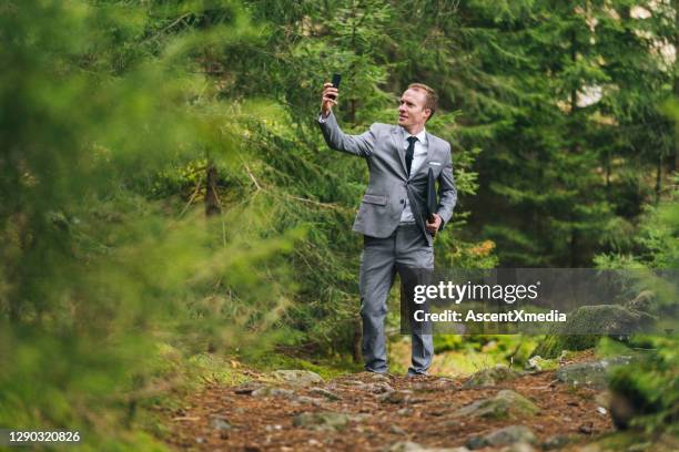 business man works remotely in lush forest in the morning - people speaking great background stock pictures, royalty-free photos & images