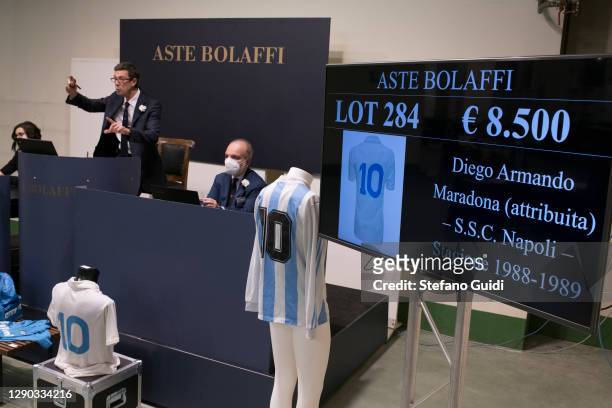 Auctioneer sells a Diego Armando Maradona shirt during of the "Sport Memorabilia" auction on December 09, 2020 in Turin, Italy. "Sport Memorabilia"...