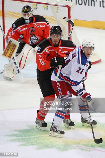 Derek Stepan of the New York Rangers battles for position with Fabian Sutter of EV Zug at the Bossard Arena during the 2011 NHL Compuware Premiere...