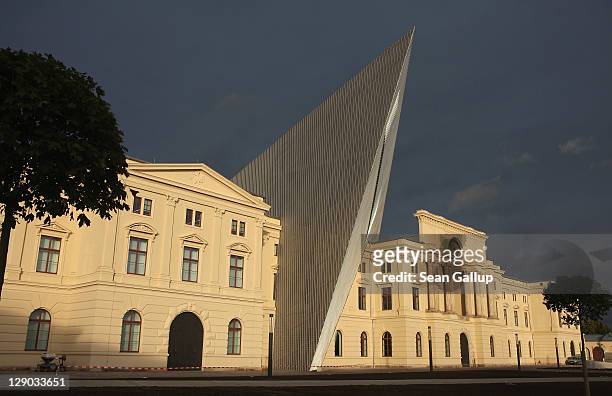 The setting sun strikes the exterior of the new Bundeswehr Military History Museum under dark clouds on October 11, 2011 in Dresden, Germany. The...