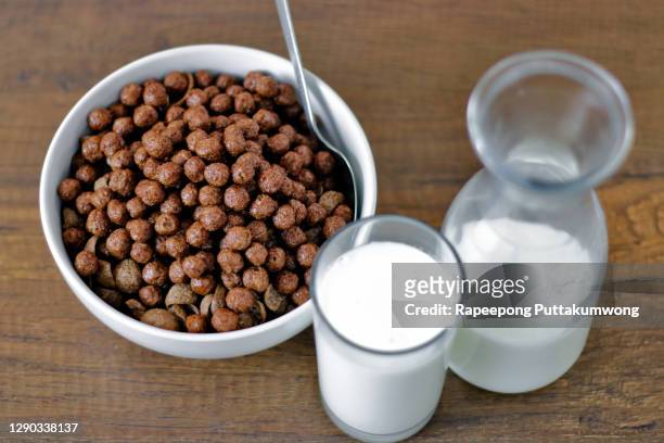 chocolate cereals in a bowl with milk - chocolate milk splash stock pictures, royalty-free photos & images