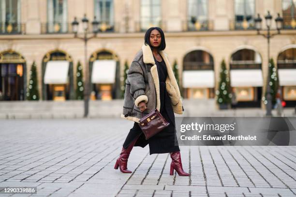 Fashion blogger Linaose wears a "bombardier" aviator brown/gray jacket with sheep wool inner lining from Acne Studio, a black slit dress from Sancia,...