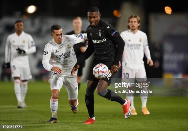 Marcus Thuram of Borussia Monchengladbach is challenged by Lucas Vazquez of Real Madrid during the UEFA Champions League Group B stage match between...