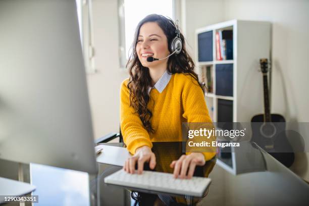 young woman having video call on computer at home - virtual seminar stock pictures, royalty-free photos & images