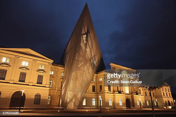 The new Bundeswehr Military History Museum stands illuminated at twilight on October 11, 2011 in Dresden, Germany. The museum, redesigned by star...
