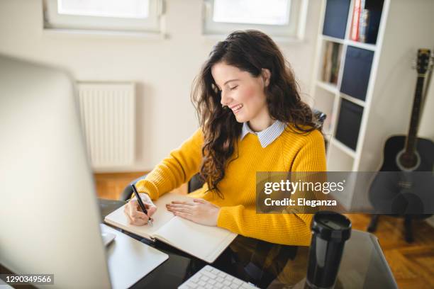 beautiful young woman having online class and learning at home - agenda diary stock pictures, royalty-free photos & images