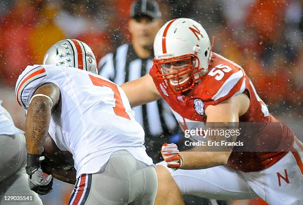 Defensive tackle Baker Steinkuhler of the Nebraska Cornhuskers draws a beed on running back Jordan Hall of the Ohio State Buckeyes during their game...