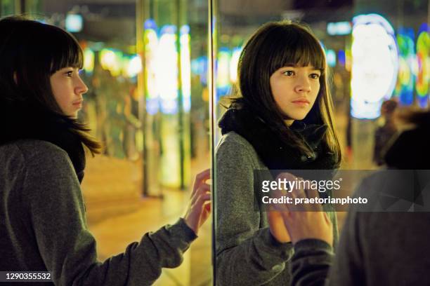 depressed young girl is looking herself in a mirror - mental illness child stock pictures, royalty-free photos & images