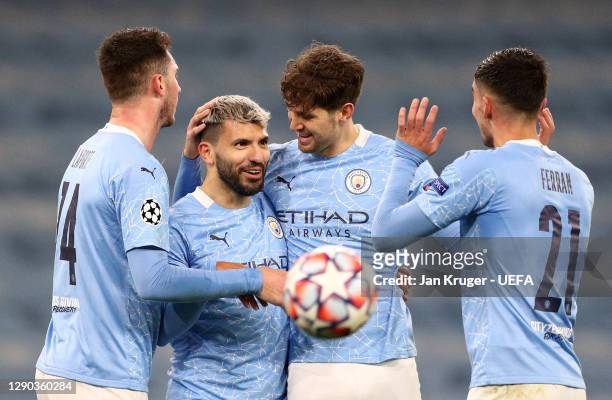 Sergio Aguero of Manchester City celebrates with teammates Aymeric Laporte, John Stones and Ferran Torres after scoring their team's second goal...