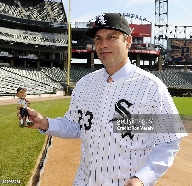Robin Ventura of the Chicago White Sox finds a bobble head doll of head groundskeeper Roger Bossard waiting for him at third base following the press...