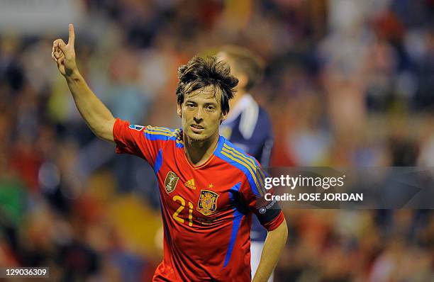 Spain's forward David Silva celebrates after scoring during the Euro 2012 qualifying football match between Spain and Scotland at the Rico Perez...