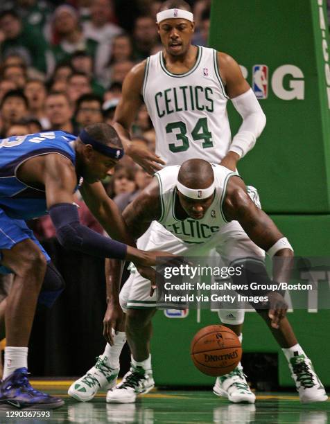 Boston Celtics center Jermaine O'Neal and Dallas Mavericks center Brendan Haywood battle for the loose ball as Boston Celtics small forward Paul...