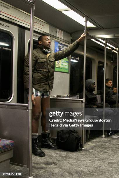 -- Alua Aumade of Boston, stands on the Red Line after removing his pants during the 2015 No Pants Subway Ride on Jan. 11, 2015. Herald Photo by...