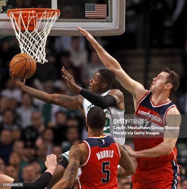 Boston Celtics guard Terry Rozier moves through Washington Wizards forward Markieff Morris and forward Jason Smith for two points during the first...