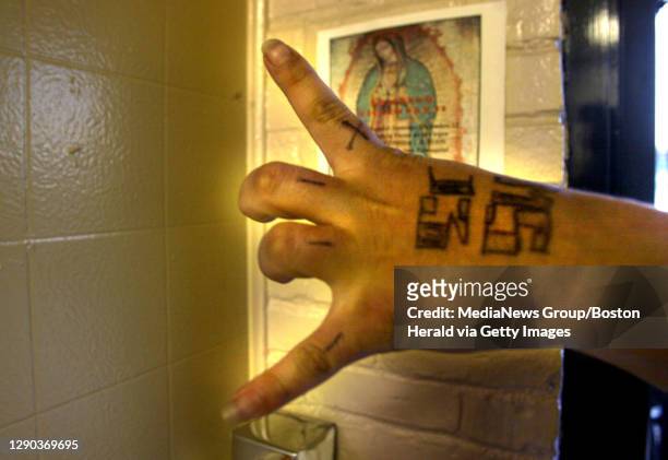 East Boston reraction to the MS13 gang. A young man shows his ms13 insignia &#10;