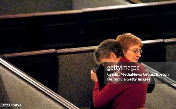 Andrea Davis, right, and Edythe Salzman, left, embrace following a memorial sevice at Arlington St Church Wednesday marking the 10 year anniversary...