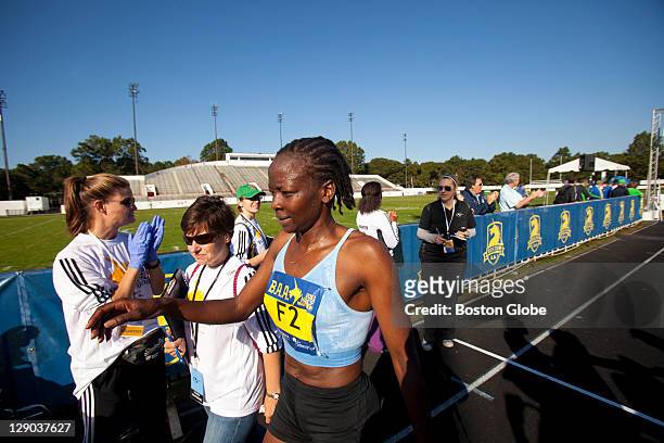 The top female finisher Janet Cherobon-Bawcom, of Rome, Ga., reached for water after crossing the finish line. The Boston Athletic Association 2011...