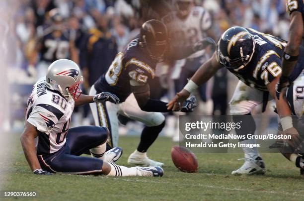 In the new play of the game, the ball is loose after New England Patriots wide receiver Troy Brown stripped the ball from San Diego Chargers safety...