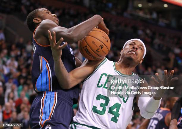 Charlotte Bobcats small forward Michael Kidd-Gilchrist and Boston Celtics small forward Paul Pierce wrestle for a rebound in the first quarter at TD...