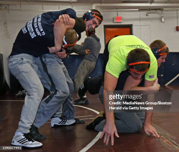 Walpole High School wrestlers from left to right, Luke Wassel, Aidan Fitzgerald, Sean McCullough, and Patrick Lanahan work through their moves during...